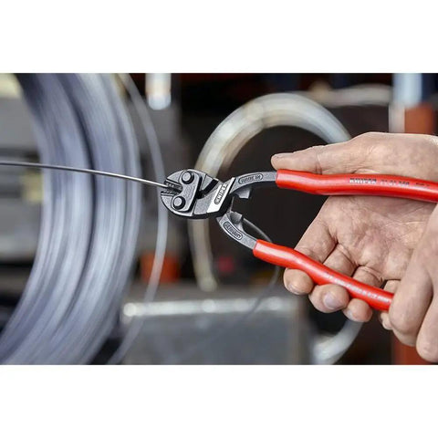 Person using CoBolt Compact Bolt Cutter With Notched Blade, 10-Inch Heavy Duty Wire Cutter for bolts, nails, rivets.