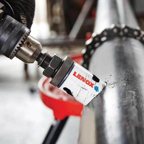 Lenox 2-3/4 in bi-metal speed-slot hole saw mounted on a drill chuck against a metal pipe.