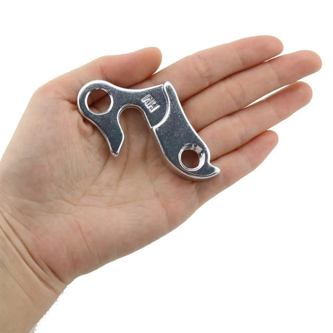 Person holding one piece of Two Pack Aluminum Alloy Rear Derailleur Hangers For Mountain And Road Bikes Go-To Universal Transmission Rack Guard
