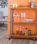 Wooden shelf on swivel caster wheels for three quarter inch pipe, showcasing bottles and glasses, highlighting mobility and tool-free assembly.
