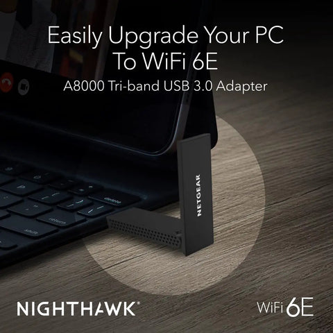 WiFi 6E USB Adapter For PC AXE3000 3Gbps Tri Band Wireless next to laptop on wooden table