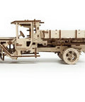 Hands On Mechanical Truck Puzzle Kit With Rubber Band Engine, 3D Wooden Construction Set, DIY Build For Adults And Teens, Realistic Pistons Under Foldable Hood, Functional Steering, Cabin Door, And Working Chassis. side view of assembled wooden truck model with open cab and flatbed
