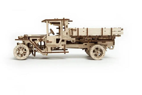 Hands On Mechanical Truck Puzzle Kit With Rubber Band Engine, 3D Wooden Construction Set, DIY Build For Adults And Teens, Realistic Pistons Under Foldable Hood, Functional Steering, Cabin Door, And Working Chassis. side view of assembled wooden truck model with open cab and flatbed