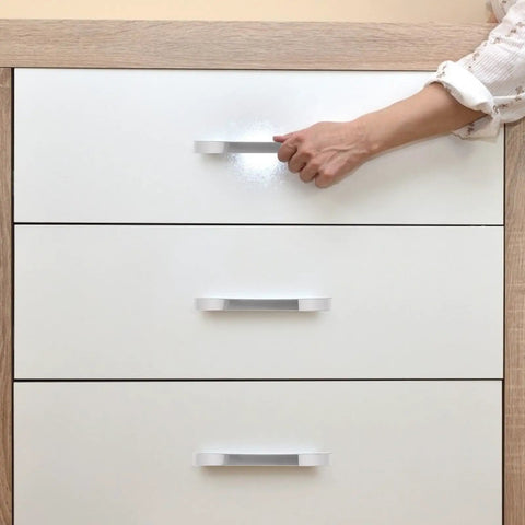 Person using 10 Pieces Zinc Alloy Wardrobe Handles And Drawer Pulls, Modern Silver Cabinet Door Pulls with 128mm Hole Spacing on dresser