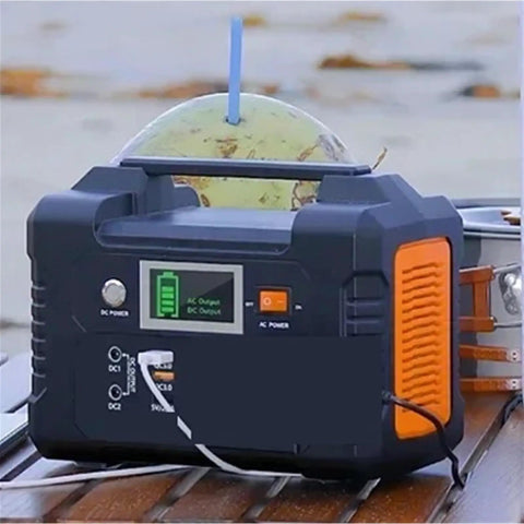 Portable AC Power Station With Fast Charging Ports, Campground Essential Backup Generator For Road Trips, Camper Vans, Drones And Storm Outages, Power Your Squad Gear Anytime No Sweat Or Fuss on wooden surface with battery indicator.