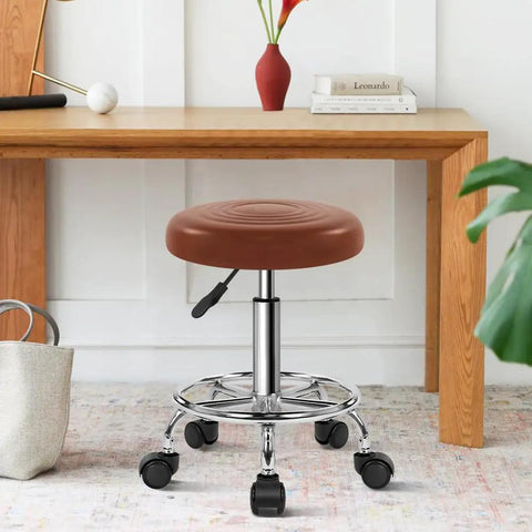 Small brown PU Leather Rolling Stool With Wheels Footrest 360 Degree Swivel Height Adjustable Chair in home setting