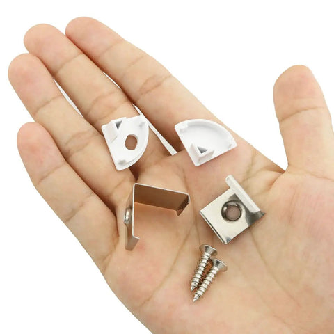 Components from LED Channel Aluminum Track Kit With 24 Pieces Mounting Clips, End Caps, Diffuser, And Screws for installation on a hand