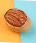 Close-up of a realistic resin walnut from the Twenty Piece Miniature Resin Nut Embellishments For Dollhouse Food Props on colorful backdrop.