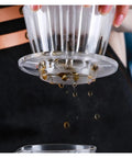 Straight Fire Premium Glass Pour Over Coffee Dripper Boasts Crystal Eye Viewing Window in use with coffee dripping through.