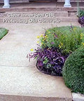 Superior Heavy Duty One Step Concrete Sealer And Curing Compound With Deep Penetrating Internal Moisture Vapor Barrier For Natural Stone And Cultured Rock Hella Tough Zero Hassle Protection applied on a sidewalk with flower beds.