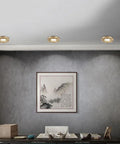 Three Pack Of 10 Sleek LED Recessed Downlights Featuring Slick Brass Baffle Trim In Stylish Gray Interior Setting.