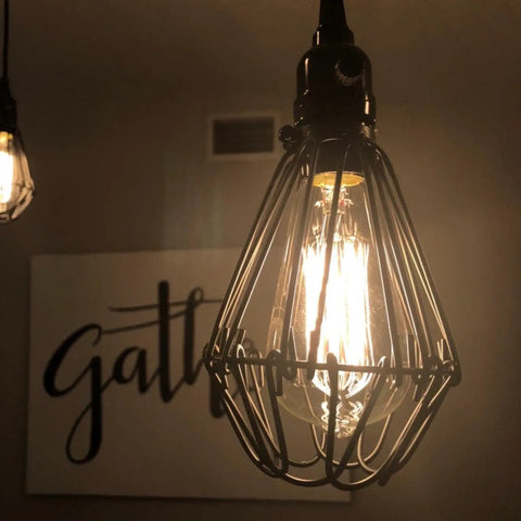 A dim-lit pendant light featuring Vintage Style 25W Incandescent Clear Glass Bulbs For Home Lighting Amber Warm 2700K 110V 6 Pack.
