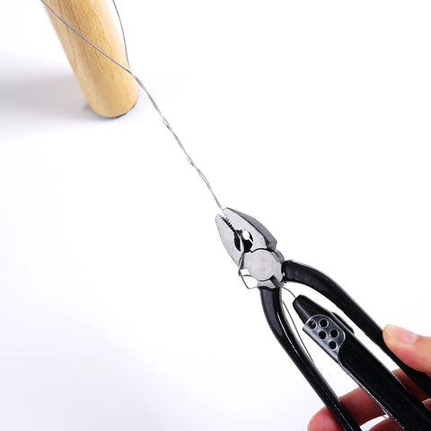 Close-up of 6 Inch Safety Wire Pliers With 25 Feet Stainless Steel Wire using black handles for twisting wire around a tool