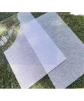 Transparent sheets on grass, outdoor setting
