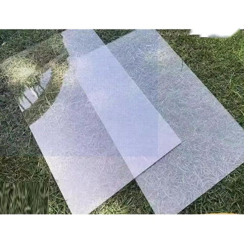 Transparent sheets on grass, outdoor setting