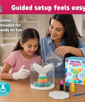 Mermaid Crystal Growing Kit For Kids 6 To 8, STEM Craft Toy That Grows Sparkling Crystals On A Mermaid Tail, Totally Screen-Free, Hands-On Science And Art Project For Young Scientists. Girl and adult pouring water into mermaid tail crystal kit