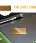 Awesome 4 PCS Golden Welding Helmet Glass Filter Lens replacement showcasing polished edges on a work surface.