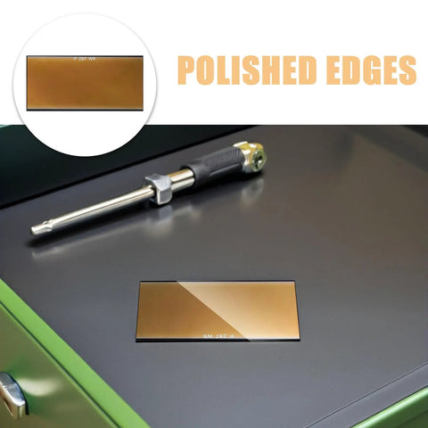 Awesome 4 PCS Golden Welding Helmet Glass Filter Lens replacement showcasing polished edges on a work surface.