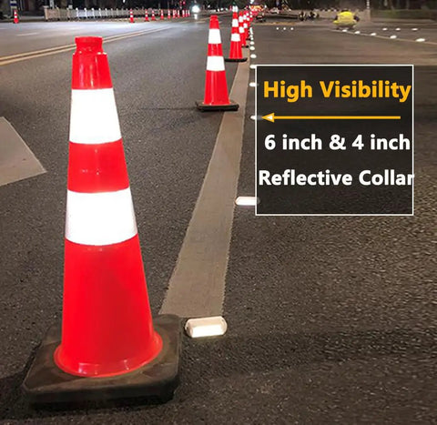 Eight 28 Inch Orange PVC Traffic Cones With Black Base in a row on a road at night, showcasing high visibility with reflective collars.