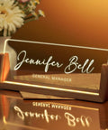 Personalized Acrylic Desk Name Plate With Light Up Base on desk with 'Jennifer Bell General Manager' engraved.