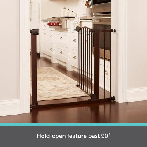 Stone Arch Auto Close Baby Gate For Doorways Bronze Metal Safety Gate shown in kitchen doorway with hold-open feature