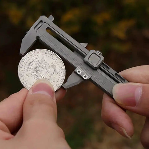 Pocket Vernier Caliper Ruler 0 To 50mm For Precise Outer Inner Diameter Measurements shown measuring a coin