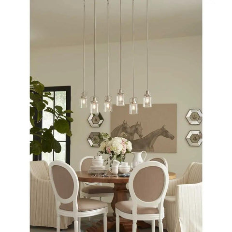 Dining room with horseshoe art, white chairs around wooden table, elegant hanging lights above for Topsail Three Light Inverted Pendant in Polished Chrome.