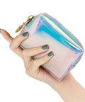 Hand holding iridescent Everyday Mini First Aid Kit For Women And Moms, Compact Purse Emergency Kit With 27 Essentials