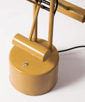 Base of Halotech 29-Inch LED Desk Lamp With Counter-Balance Arm, yellow finish, showing touch dimmer on sleek steel design