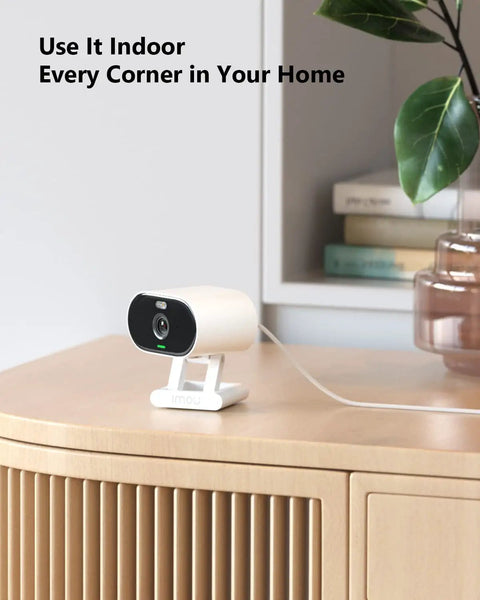 Outdoor Indoor Security Cam 1080P 2.4Ghz WiFi Color Night Vision Spotlight IP65 Waterproof on a wooden table indoors
