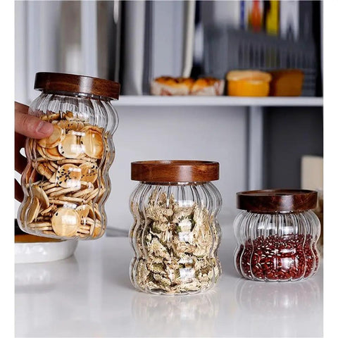 Premium Textured Glass Tea Canisters For Loose Leaf Coffee Beans And Pantry Essentials with wooden lids holding snacks and herbs.
