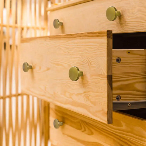 Open wooden drawer with 50 Pack Matte Black Drawer Knobs for Cabinets and Dressers One And A Quarter Inch Diameter Zinc Alloy Knobs.