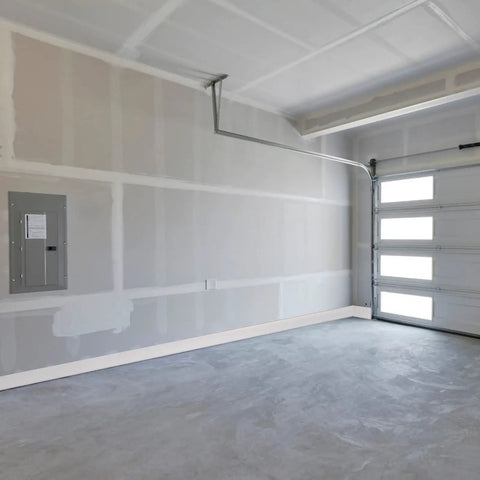 Self Adhesive 4 Inch Vinyl Wall Base Molding Peel and Stick 20 Feet White Cove Base installed in a garage setting