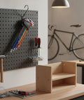 Solid 9-Piece Hex Key Set Crafted From Tough Chrome Vanadium Steel For Easy Bike Repair Furniture Assembly And Household Fixes That Get The Job Done Right. Color-coded hex keys on pegboard in workshop.