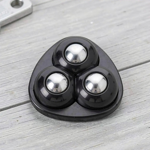 Close-up of a black 12pcs Ball Swivel Caster Wheel for Furniture and Dressers, showing three shiny metal balls on a durable base.