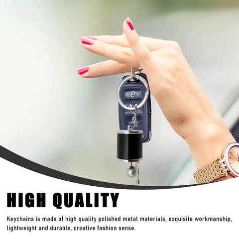 Hella Dope Two Pack Gearbox Keychain Featuring Six Speed Manual Shifter Shape with Transmission Stick Keyring held by a hand.