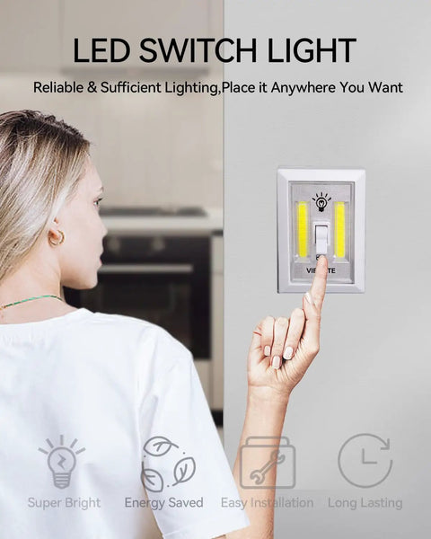 Person using 4 Pack Battery Operated Tap Light With Dual COB LED Panels Per Switch on kitchen wall.