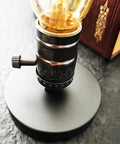 Close-up of Vintage Edison Desk Lamp With Industrial Loft Vibe, E26/E27 Plug In On Off Switch, on black metal base.
