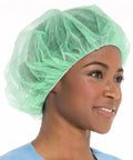 Close-up of a person wearing a Straight Up Reliable Disposable Bouffant Cap, 24 Inch green breathable polypropylene hair net.