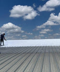 Worker applying Maximum Stretch Waterproof Sealant Membrane For Roofing, Repairs, Concrete, EPDM And Wood on metal roof
