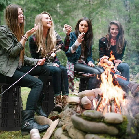 Group sitting on Upgraded Collapsible Camping Stool With Reinforced Buckles around campfire