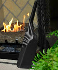 Black weather resistant fireplace shovel beside indoor fire, 15in length, rust prevention coating, durable hearth shovel.