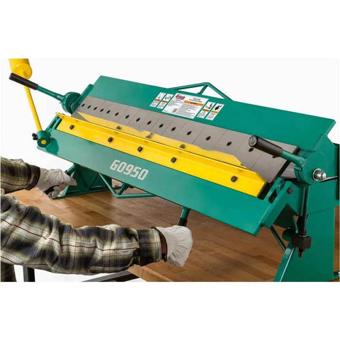 User operating 48 Inch Pan And Box Brake For 16 Gauge Sheet Metal, Heavy Duty Bench Type with full trussed rigidity and 16 interchangeable fingers.