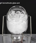 Smooth Sippin Cold Brew Drip Coffee Maker With Stainless Filter And Adjustable Flow Yields Barista Style Drinks Via Glass Carafe On Acrylic Stand Makes 3 To 6 Cups shows high borosilicate glass pot filled with ice.