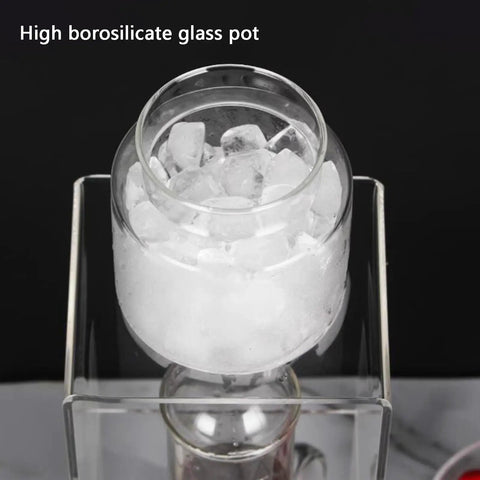 Smooth Sippin Cold Brew Drip Coffee Maker With Stainless Filter And Adjustable Flow Yields Barista Style Drinks Via Glass Carafe On Acrylic Stand Makes 3 To 6 Cups shows high borosilicate glass pot filled with ice.