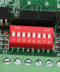 Close-up of 8 Channel Level Converter For 5V To 24V And 24V To 5V NPN PNP To NPN Square Wave with DIP switches and optocoupler.