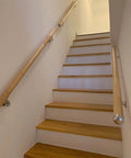 Heavy Duty Built Tough Non Slip PVC Handrail 18 Feet Long All Weather Deck Railing Kit With Easy Install Wall Brackets Wood Tone Finish, installed on indoor stairs.