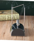 Z Shape Newton Cradle Pendulum Desk Toy For Home Office Decor with silver finish on a wooden desk for educational use