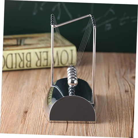 Z Shape Newton Cradle Pendulum Desk Toy For Home Office Decor with silver finish on a wooden desk for educational use