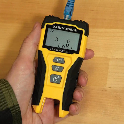 Person holding LAN Scout Jr 2 Ethernet Cable Tester For CAT5e CAT6 CAT6A RJ45 Cables With Backlit LCD Wiremap